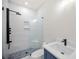 Bathroom with walk-in shower, marble tile, and blue vanity at 2251 Old Atlanta Rd, Cumming, GA 30041
