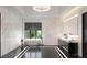 Modern bathroom with marble walls and a soaking tub at 2251 Old Atlanta Rd, Cumming, GA 30041