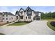 Two-story home with light stone exterior and a large driveway at 2251 Old Atlanta Rd, Cumming, GA 30041