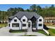 Stunning two-story home with white brick and gray roof at 2251 Old Atlanta Rd, Cumming, GA 30041