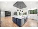 Open concept kitchen with white cabinets, a navy island, and hardwood floors at 2251 Old Atlanta Rd, Cumming, GA 30041