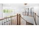 Modern staircase with wooden railing overlooking the living area at 2251 Old Atlanta Rd, Cumming, GA 30041
