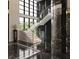 Modern marble staircase with glass railings and wine cellar at 2251 Old Atlanta Rd, Cumming, GA 30041