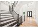 Modern staircase with dark wood steps and metal railing at 2251 Old Atlanta Rd, Cumming, GA 30041