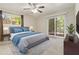 Main bedroom with sliding glass doors to deck, ceiling fan and virtually staged furniture at 5595 Deerfield Trl, Atlanta, GA 30349