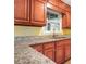 Kitchen featuring granite countertops and wood cabinets at 141 Denna Dr, Alpharetta, GA 30009