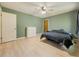 Simple bedroom with calming green walls and hardwood floors at 4283 Michelle Ct, Loganville, GA 30052