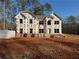 Two-story house under construction, with brick and house wrap visible at 5380 Deer Run Dr, Conyers, GA 30094