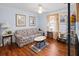 Cozy living room featuring hardwood floors and large windows at 1055 Cranberry Crk, Roswell, GA 30076