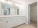 Double vanity bathroom with white cabinets and a walk-in closet at 111 Winsome Way, Woodstock, GA 30188