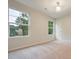 Spacious bedroom with neutral walls and carpet, featuring two windows at 844 Ridge Nw Ave, Atlanta, GA 30318