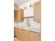 Modern kitchen with light wood cabinets, quartz countertops, and gold fixtures at 1180 Lupo Loop, Chattahoochee Hills, GA 30268