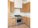 Modern kitchen with stainless steel appliances and light wood cabinets at 1180 Lupo Loop, Chattahoochee Hills, GA 30268