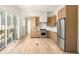 Modern kitchen with light wood cabinets and stainless steel appliances at 1180 Lupo Loop, Chattahoochee Hills, GA 30268