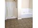 Bathroom with separate shower, soaking tub, and tile floor at 6398 Shadow Sq, Lithonia, GA 30058