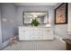 Double vanity with white cabinets and a large mirror at 1384 Jefferson Ave, East Point, GA 30344