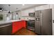 Modern kitchen with red cabinets, gray countertops, and stainless steel appliances at 1384 Jefferson Ave, East Point, GA 30344