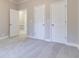 Bright bedroom with carpet, neutral walls and double closets at 1510 Natchez Way, Grayson, GA 30017