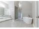 Luxurious bathroom with soaking tub, walk-in shower, and granite vanity at 1510 Natchez Way, Grayson, GA 30017