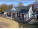 Pool house exterior with gray siding, red shutters, and a black metal roof at 247 Valley Xing, Canton, GA 30114