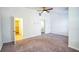 Spacious bedroom with carpet, ceiling fan and access to closet and stairs at 2158 Executive Dr, Duluth, GA 30096