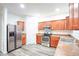 Modern kitchen with stainless steel appliances and wood cabinets at 2158 Executive Dr, Duluth, GA 30096