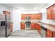 Modern kitchen with stainless steel appliances and wood cabinets at 2158 Executive Dr, Duluth, GA 30096