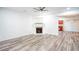 Living room with hardwood floors, fireplace and ceiling fan at 2158 Executive Dr, Duluth, GA 30096
