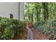 Stone pathway leads to a wooden gate, nestled beside lush greenery at 4305 E Summit Ct, Marietta, GA 30066