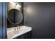 Elegant powder room with dark walls, gold fixtures, and a marble vanity at 3630 Peachtree Ne Rd # 3106, Atlanta, GA 30326