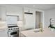 Modern white kitchen with marble countertops and stainless steel appliances at 3630 Peachtree Ne Rd # 3106, Atlanta, GA 30326