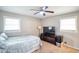 Spacious bedroom with ceiling fan and large TV at 680 Sherwood Dr, Jonesboro, GA 30236