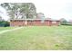 Brick ranch house with a spacious lawn at 680 Sherwood Dr, Jonesboro, GA 30236