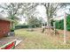 Large backyard with playset, patio furniture, and storage shed at 680 Sherwood Dr, Jonesboro, GA 30236
