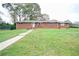 Brick ranch house with a spacious lawn at 680 Sherwood Dr, Jonesboro, GA 30236