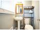 Small bathroom with pedestal sink and toilet at 680 Sherwood Dr, Jonesboro, GA 30236