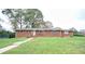 Brick ranch house with a spacious lawn at 680 Sherwood Dr, Jonesboro, GA 30236