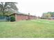 Brick ranch house with a spacious lawn at 680 Sherwood Dr, Jonesboro, GA 30236