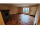 Living room with wood-look flooring, a stone fireplace, and large window at 4912 Bayside Ct, Stone Mountain, GA 30088