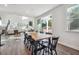 Bright dining room with a farmhouse table and chairs, leading to a view of the living room and backyard at 4011 Fallen Leaf Ct, Kennesaw, GA 30152