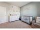 Bedroom with crib, dresser, and coastal-themed decor at 4011 Fallen Leaf Ct, Kennesaw, GA 30152