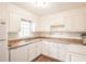 Bright kitchen featuring white cabinets, granite countertops, and modern appliances at 220 Hicks Se Dr, Marietta, GA 30060