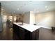 Kitchen with island, dark cabinets, and stainless steel appliances at 617 Brennan Dr, Decatur, GA 30033