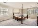 Main bedroom with a large four poster bed and carpet flooring at 2958 Applewood Ne Ct, Atlanta, GA 30345