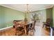 Dining room with hardwood floors, green walls, and access to deck at 2958 Applewood Ne Ct, Atlanta, GA 30345