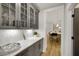Gray cabinetry with glass doors, quartz countertops and open view to kitchen at 3759 Tielman St, Snellville, GA 30078
