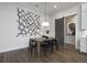 Bright dining room features a wooden table with black chairs and modern wall art at 3759 Tielman St, Snellville, GA 30078