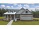 Gray two-story house with a metal roof, brick facade, and a two-car garage at 3759 Tielman St, Snellville, GA 30078