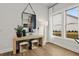 Light and bright entryway with a console table, mirror, and two ottomans at 3759 Tielman St, Snellville, GA 30078