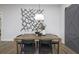 Bright dining room features a wood table, black chairs, and a statement wall accent at 3759 Tielman St, Snellville, GA 30078